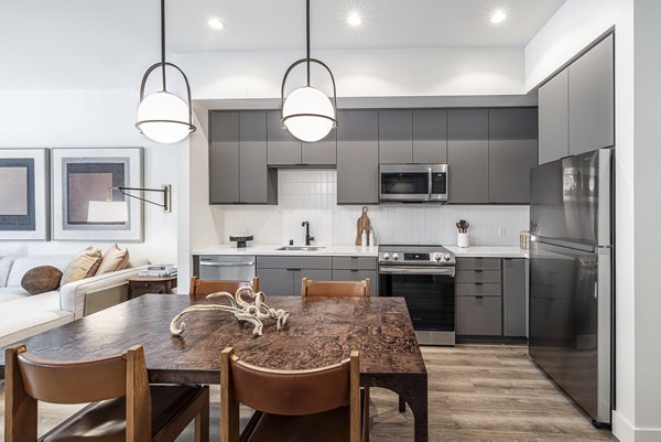 Dining area with modern furnishings at Hollywood Park Apartments featuring stylish lighting and open layout