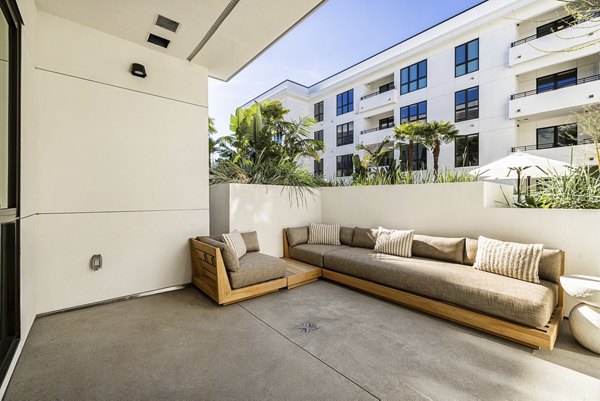 Patio view with modern seating and greenery at Hollywood Park Apartments
