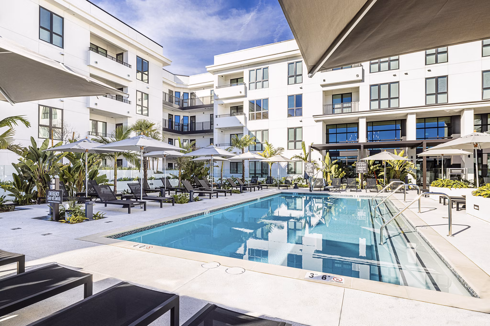 Luxury pool area with lounge chairs at Hollywood Park Apartments, offering residents a tranquil outdoor retreat for relaxation and leisure activities