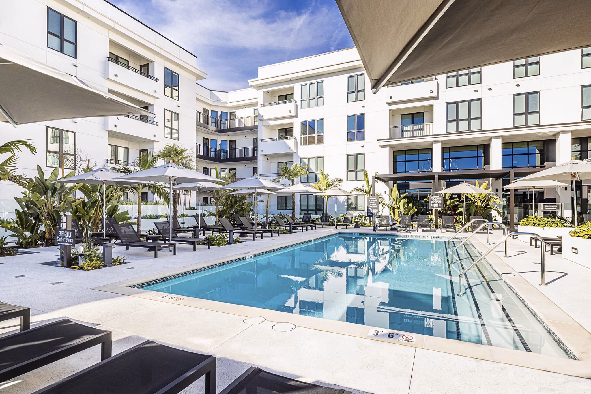 Luxury pool area with lounge chairs at Hollywood Park Apartments, offering residents a tranquil outdoor retreat for relaxation and leisure activities