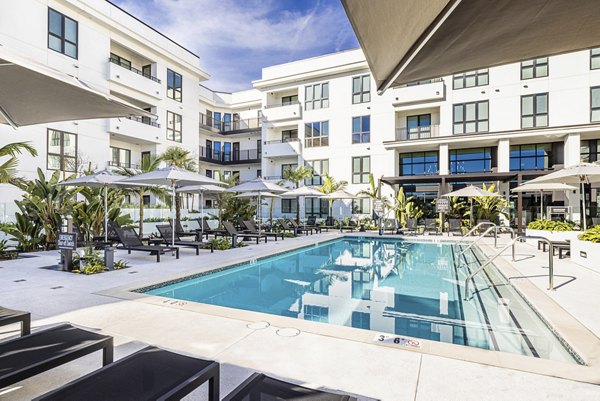 Luxury pool area with lounge chairs at Hollywood Park Apartments, offering residents a tranquil outdoor retreat for relaxation and leisure activities