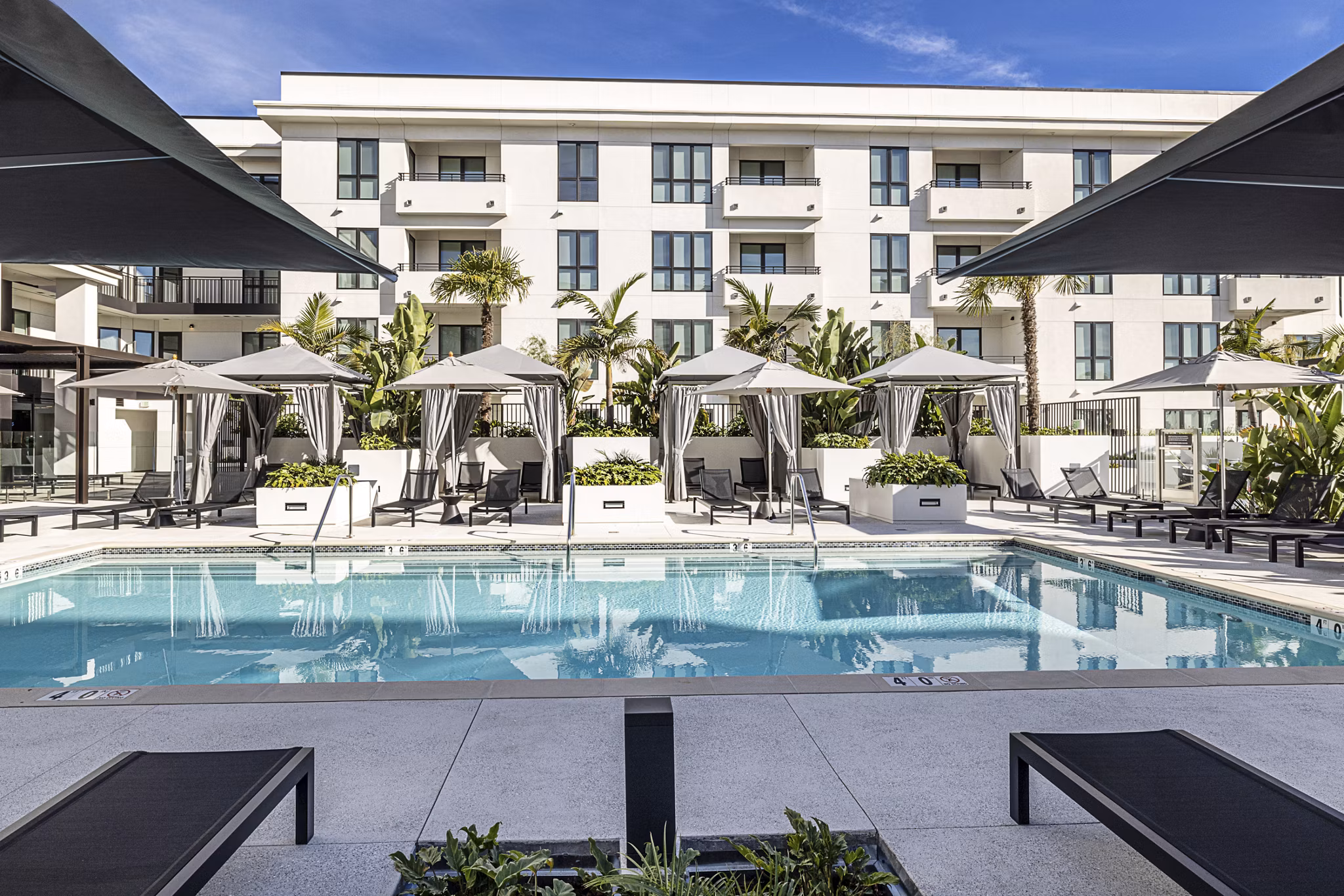 Resort-style pool with lounge seating at Hollywood Park Apartments, luxurious living in the heart of a vibrant community