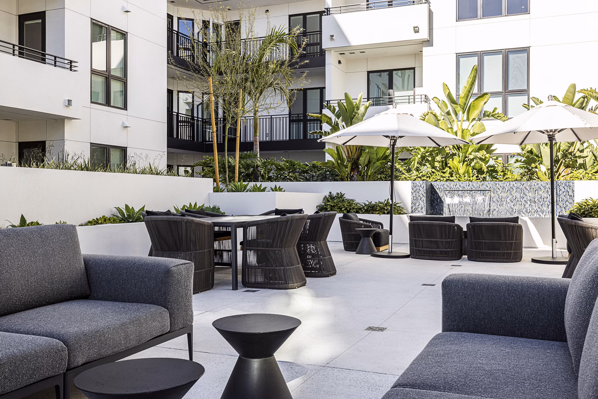 Hollywood Park Apartments: Serene courtyard with lush greenery and seating areas in a luxury apartment community