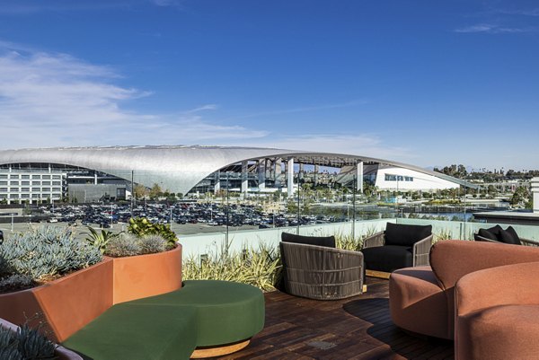 Spacious rooftop deck with outdoor seating at Hollywood Park Apartments offering panoramic city views