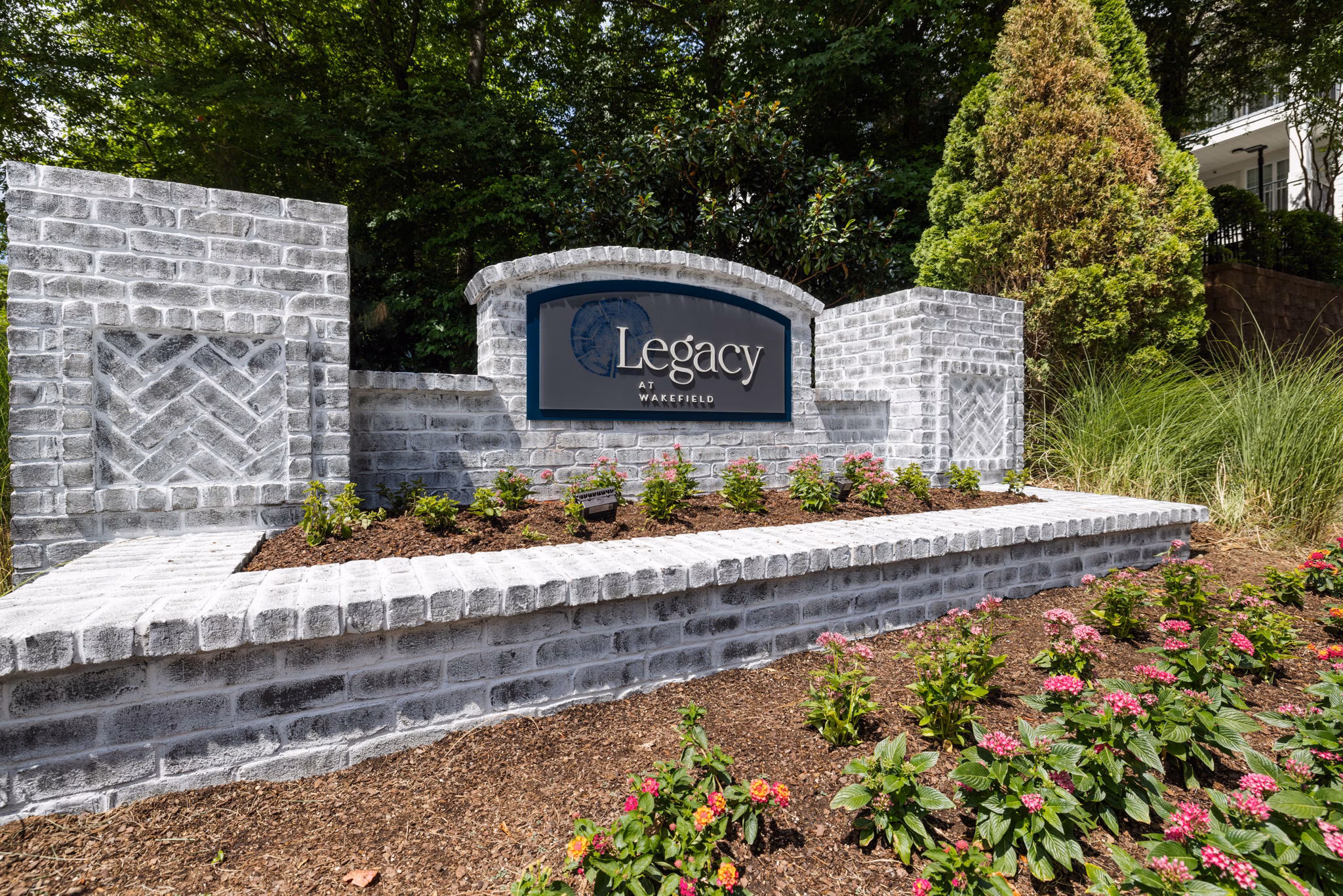 Legacy at Wakefield: Elegant signage at luxury apartments in a serene setting