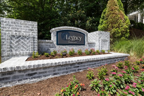 Legacy at Wakefield: Elegant signage at luxury apartments in a serene setting