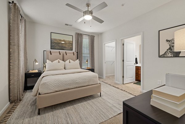 Bedroom featuring modern furnishings and natural light at Legacy at Wakefield Apartments