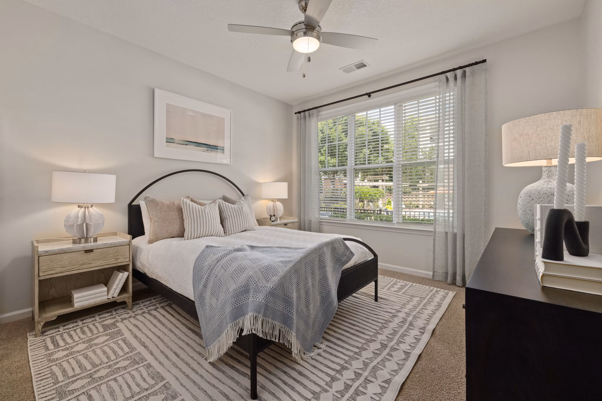 Spacious bedroom with elegant furnishings at Legacy at Wakefield Apartments, Greystar's luxury living community in a serene setting