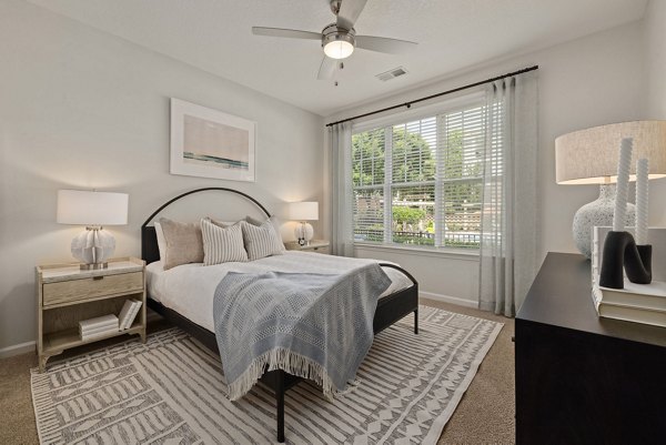 Spacious bedroom with elegant furnishings at Legacy at Wakefield Apartments, Greystar's luxury living community in a serene setting