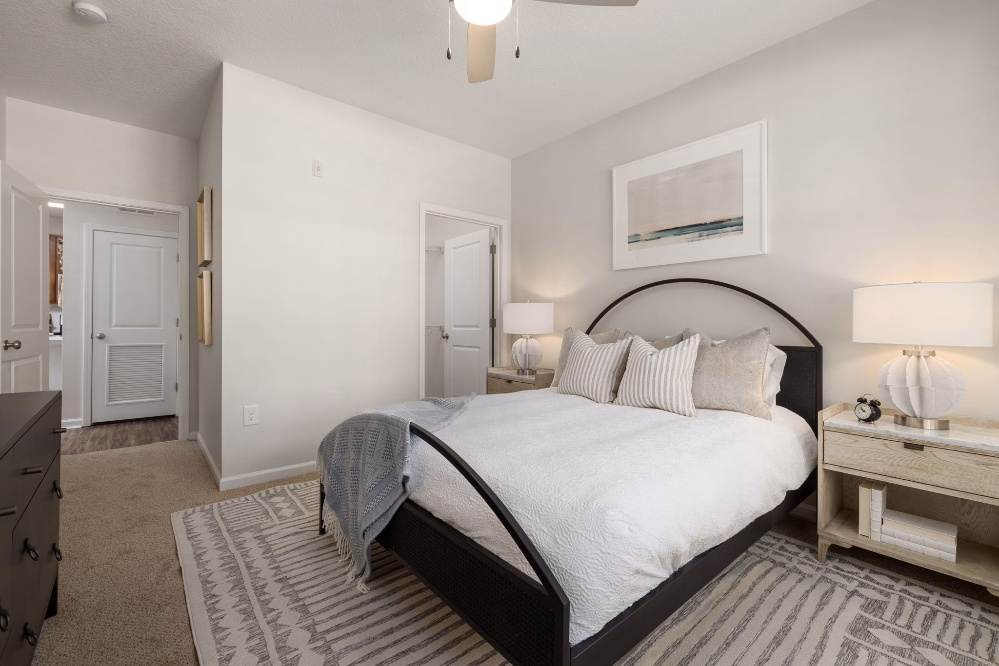 Boutique bedroom with plush carpeting and natural light at Legacy at Wakefield Apartments