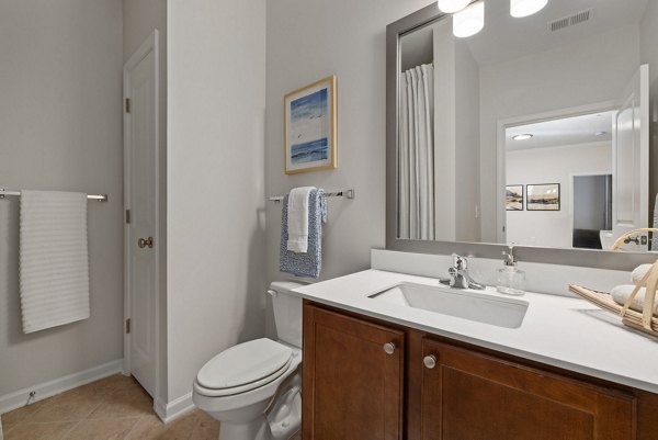 Modern bathroom with dual sinks and elegant fixtures at Legacy at Wakefield Apartments