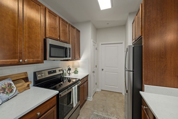 Modern kitchen with stainless steel appliances and granite countertops at Legacy at Wakefield Apartments