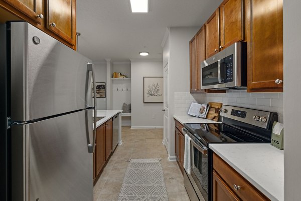 Modern kitchen with stainless steel appliances in Legacy at Wakefield Apartments Perfect for culinary enthusiasts seeking luxury living