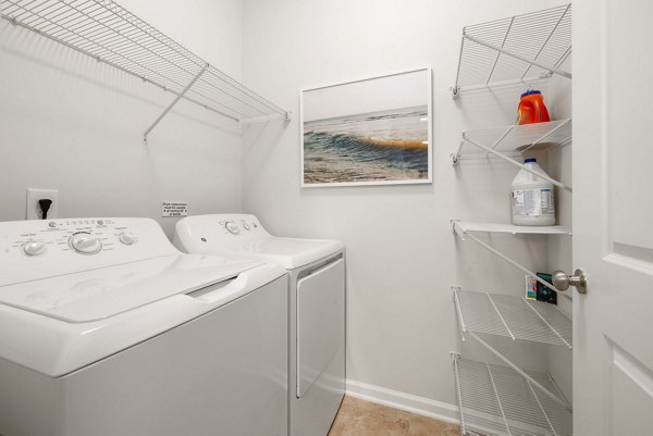 Laundry room featuring modern appliances at Legacy at Wakefield Apartments