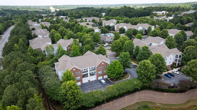 Legacy at Wakefield: Elegant view of luxury apartments with landscaped surroundings