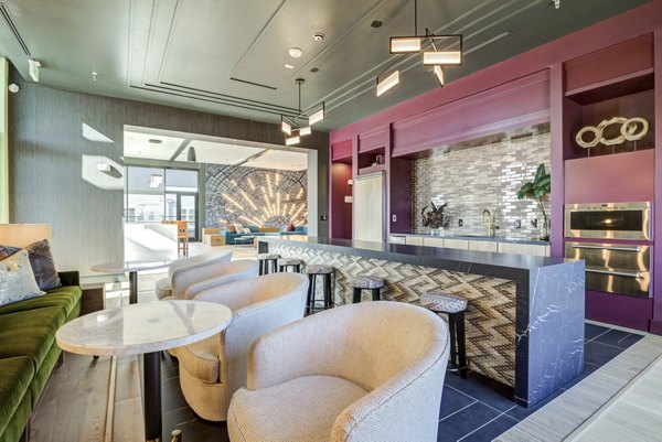 Modern clubhouse with stylish seating and entertainment options at NOMA Apartments