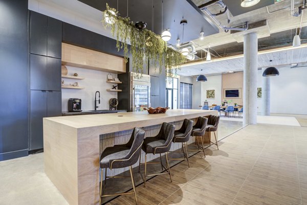 Sophisticated clubhouse featuring modern furnishings at NOMA Apartments Perfect space for residents to relax and socialize