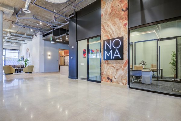 Modern clubhouse with upscale design at NOMA Apartments, featuring social areas and a stylish environment for residents