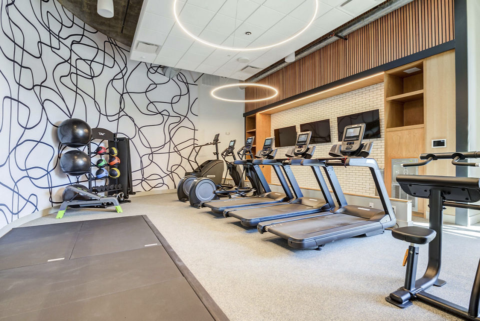State-of-the-art fitness center with modern equipment at NOMA Apartments