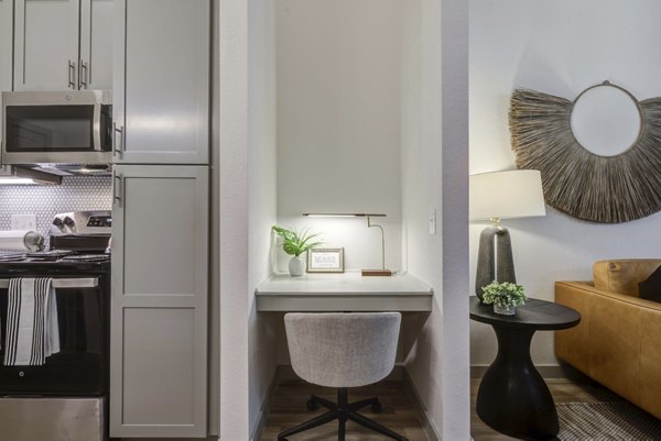 Modern kitchen with stainless steel appliances at NOMA Apartments