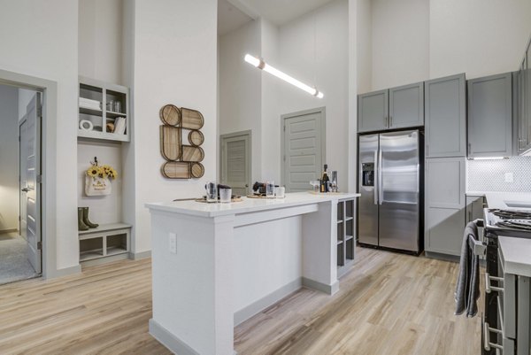 Spacious modern kitchen with stainless steel appliances at NOMA Apartments, a Greystar luxury property