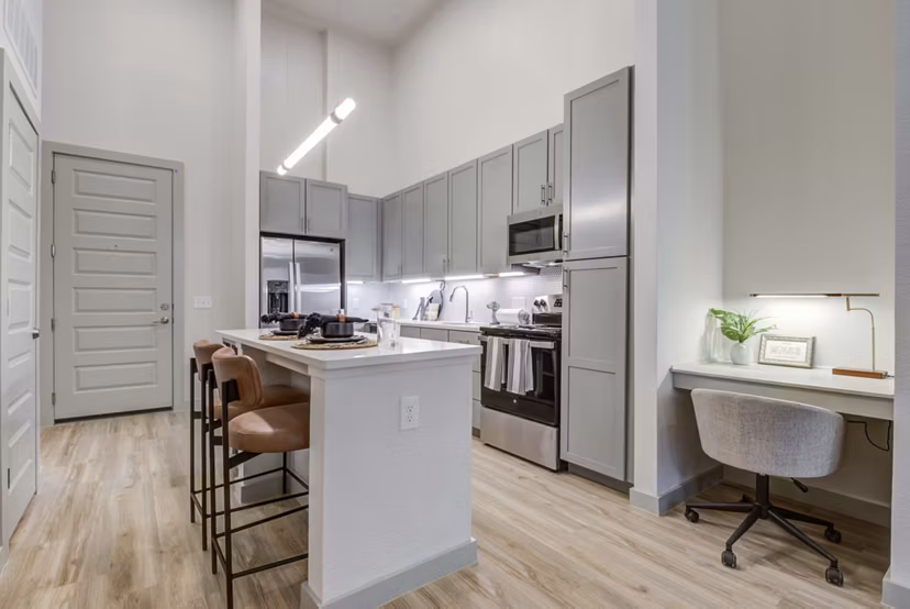 Modern kitchen with sleek cabinetry and stainless steel appliances at NOMA Apartments in the Greystar luxury collection
