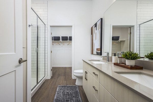 Modern bathroom featuring sleek fixtures and ample storage at Braxton Apartments, high-end living by Greystar in a vibrant community