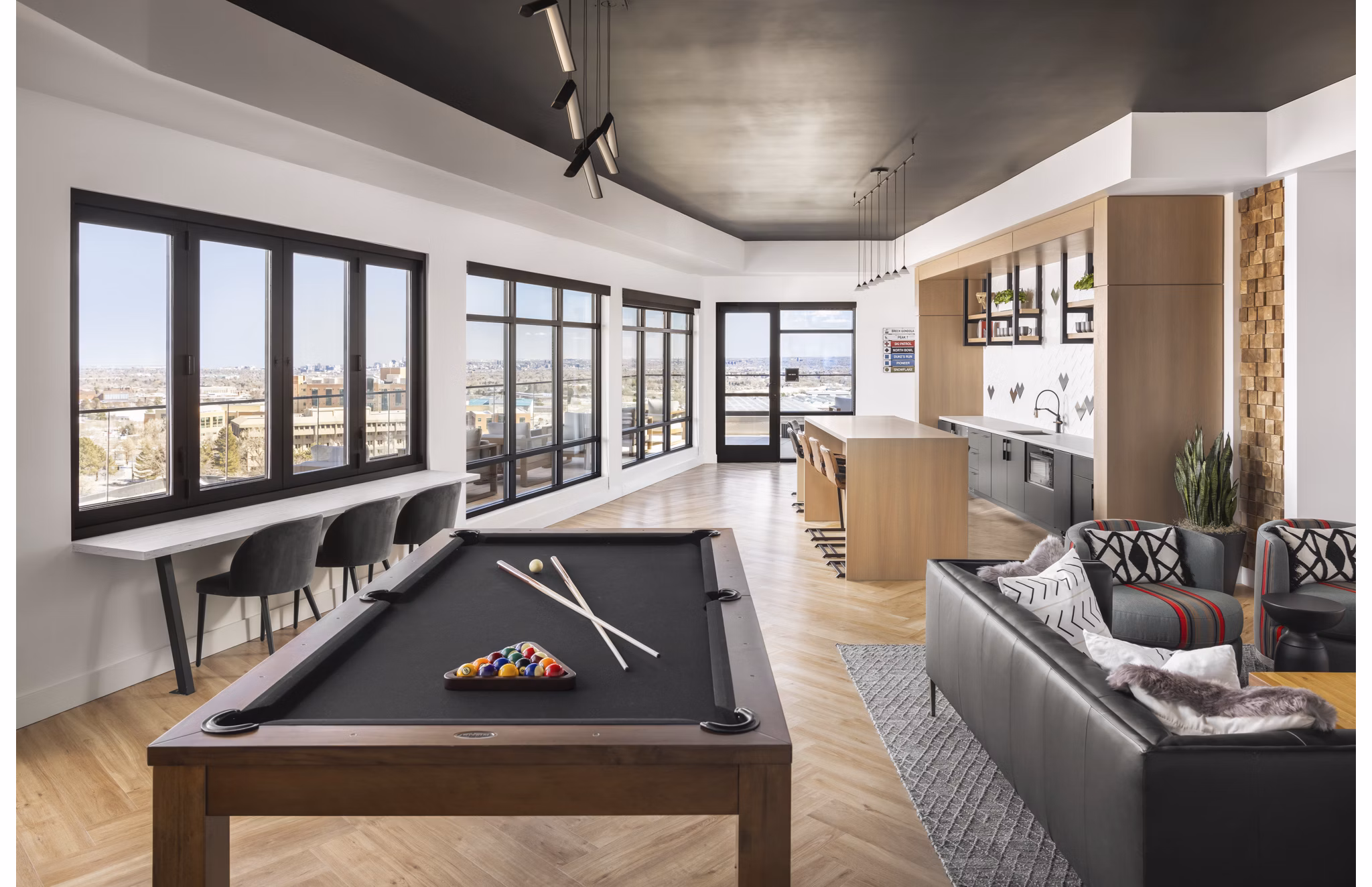 Clubhouse game room with billiards and seating area at Braxton Apartments