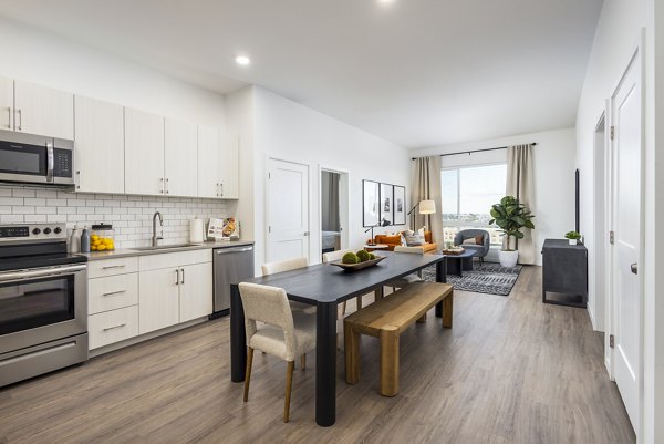 Dining room and kitchen with modern finishes at Braxton Apartments: Luxury apartment living spaces