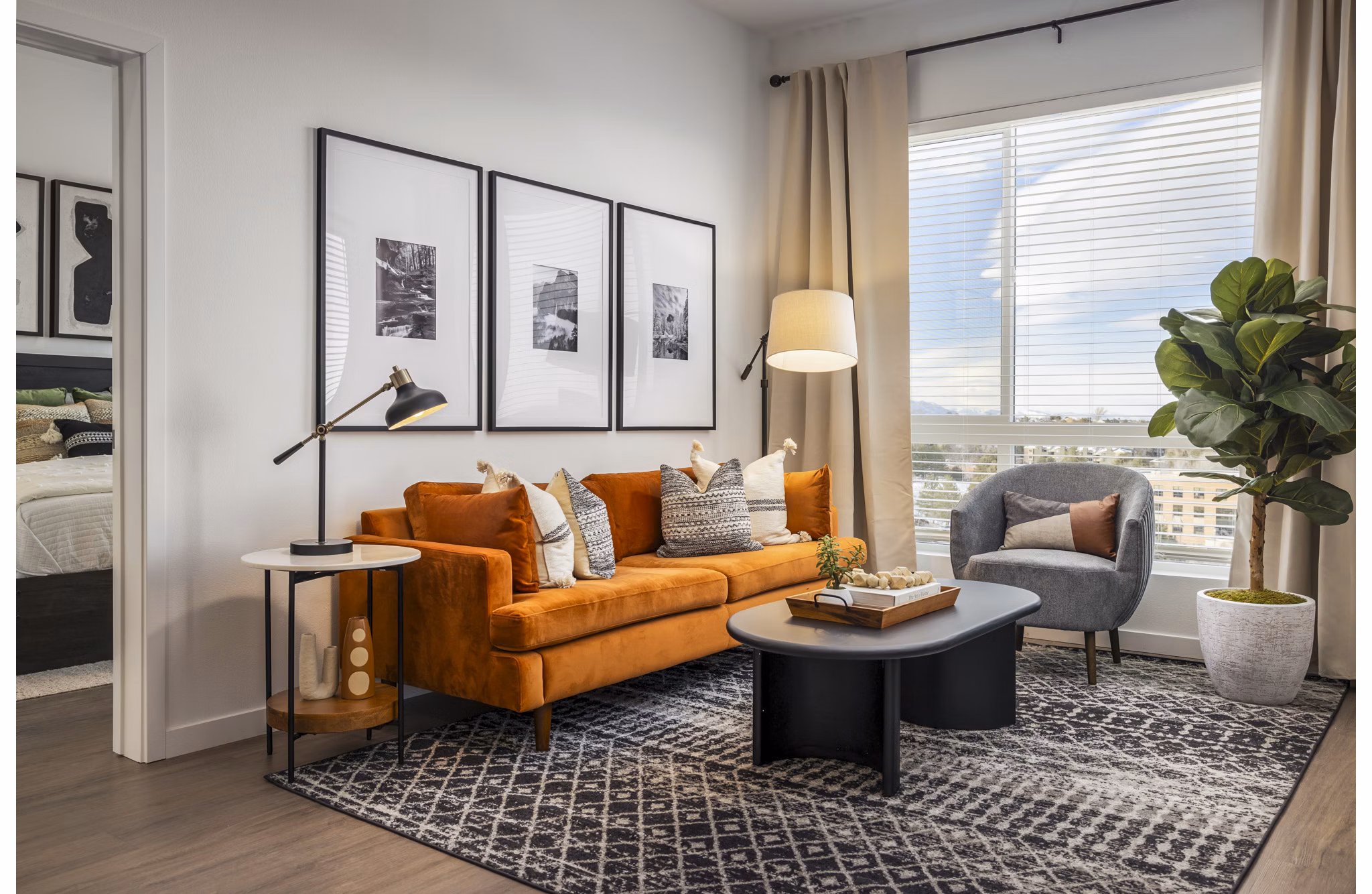 Spacious living room with modern decor and natural light in Braxton Apartments