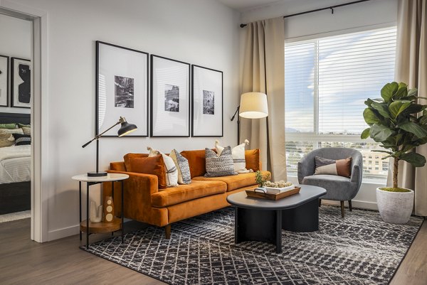 Spacious living room with modern decor and natural light in Braxton Apartments