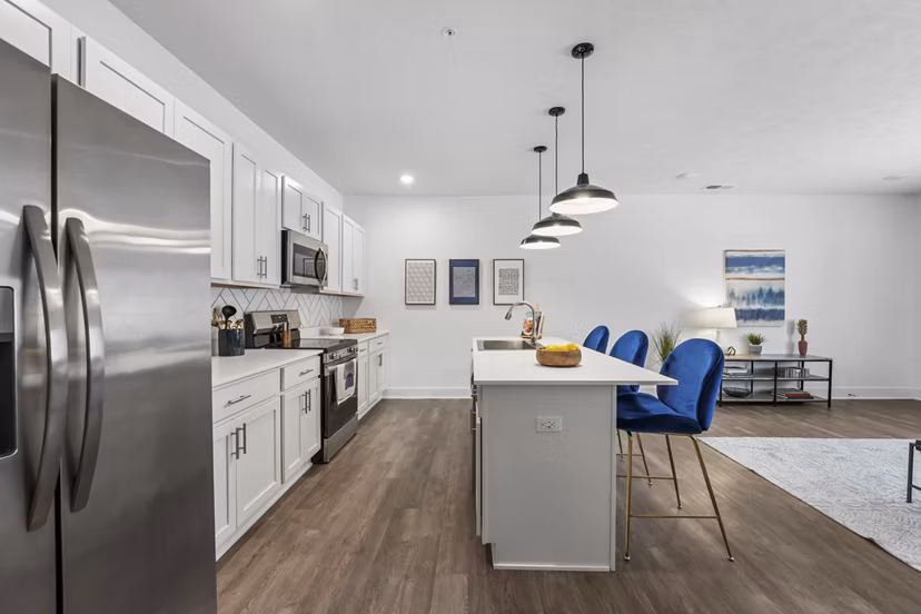 Modern kitchen with sleek countertops and stainless steel appliances at Capriana Apartments