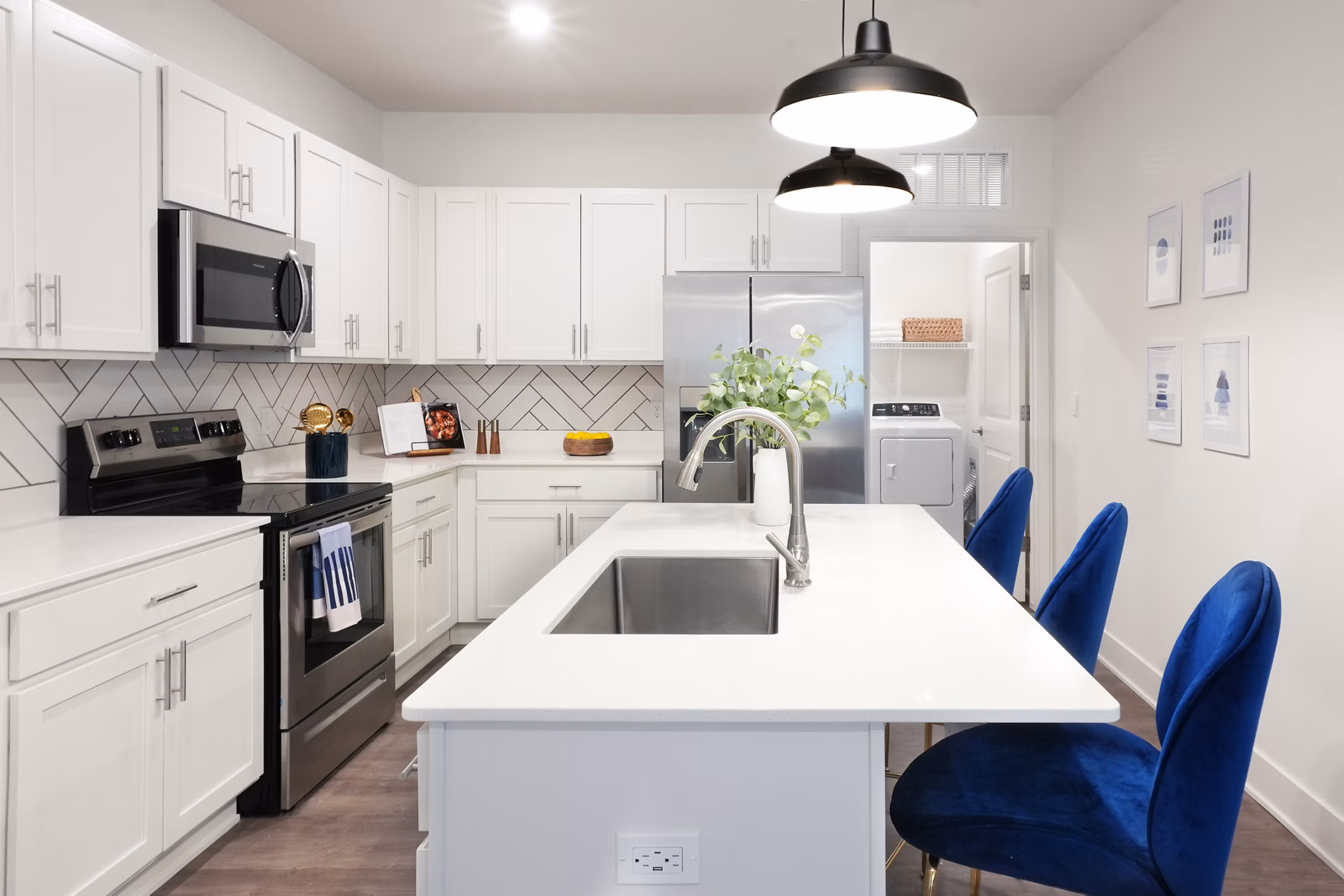 Modern kitchen with sleek countertops and stainless steel appliances at Capriana Apartments
