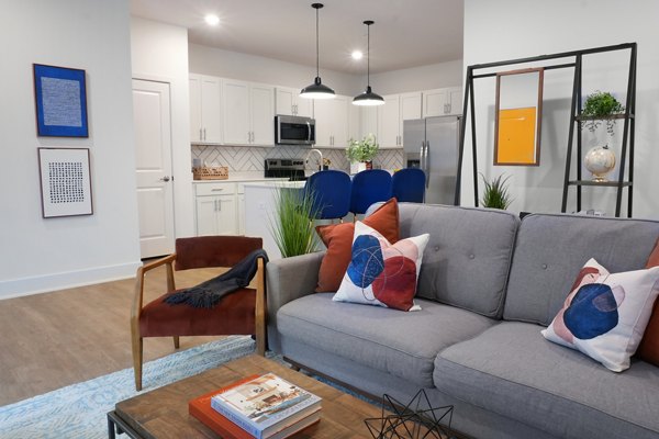 Cozy living room with elegant decor and plush seating in Capriana Apartments