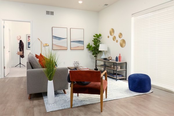 Modern living room with cozy seating and stylish decor at Capriana Apartments