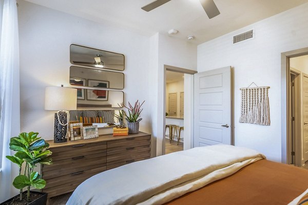 Cozy bedroom with modern design and plush bedding at The Chloe Leander Apartments, offering luxury living in a prime location