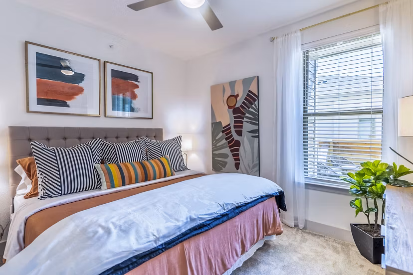 Cozy bedroom with modern furnishings at The Chloe Leander Apartments