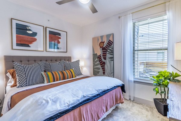 Cozy bedroom with modern furnishings at The Chloe Leander Apartments
