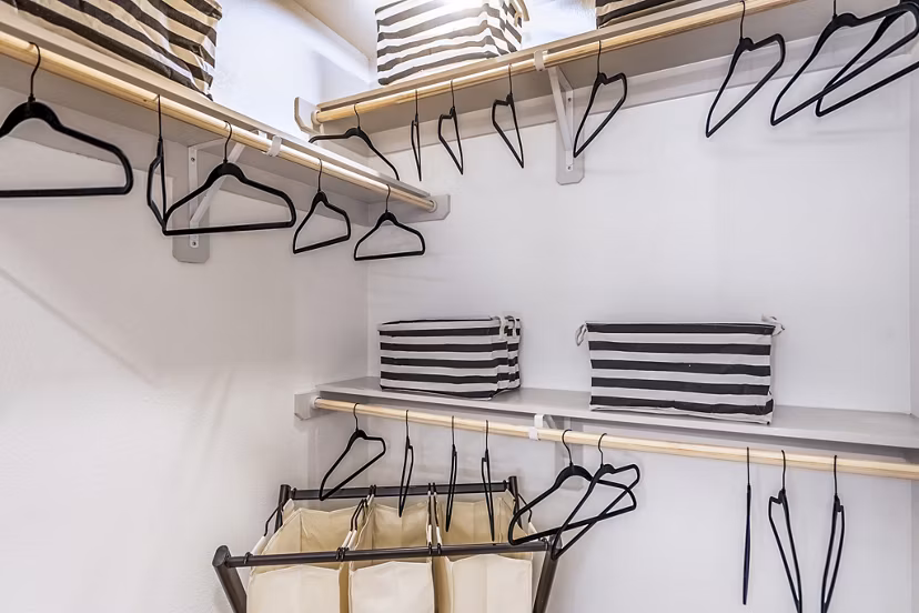 Walk-in bedroom closet with ample shelving at The Chloe Leander Apartments, offering organized storage solutions for luxury living
