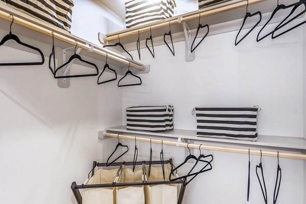 Walk-in bedroom closet with ample shelving at The Chloe Leander Apartments, offering organized storage solutions for luxury living
