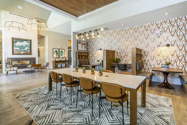 Clubhouse featuring modern design and cozy seating at The Chloe Leander Apartments in a Greystar community