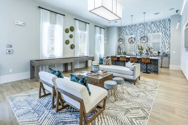 Clubhouse lounge featuring modern seating and vibrant decor at The Chloe Leander Apartments in a luxurious community