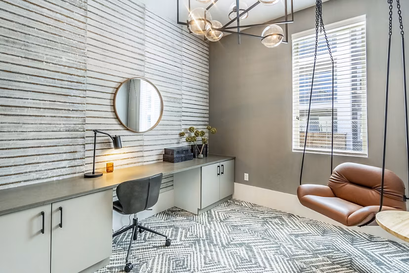 Clubhouse business center with modern workstations at The Chloe Leander Apartments, offering a productive environment