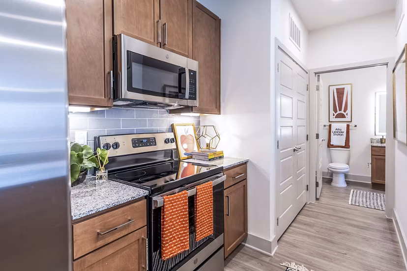 Modern kitchen with stainless steel appliances at The Chloe Leander Apartments