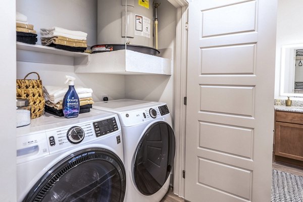 Laundry room with energy-efficient washers and dryers at The Chloe Leander Apartments