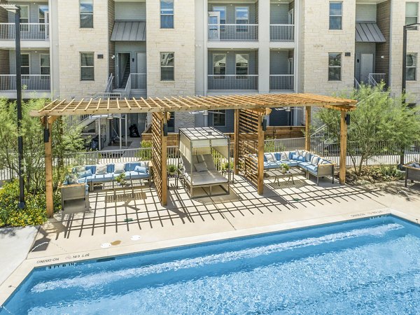 Outdoor pool and spacious patio area at The Chloe Leander Apartments