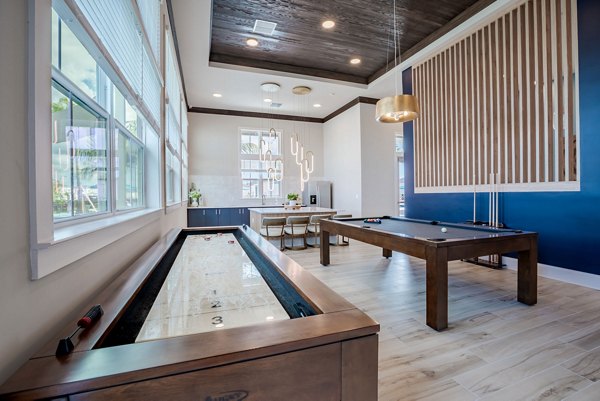 Game room with billiards table and lounge seating at Eden Heritage Lakes Apartments