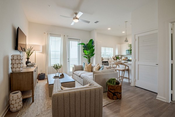 Spacious living room with modern decor and natural lighting at Eden Heritage Lakes Apartments