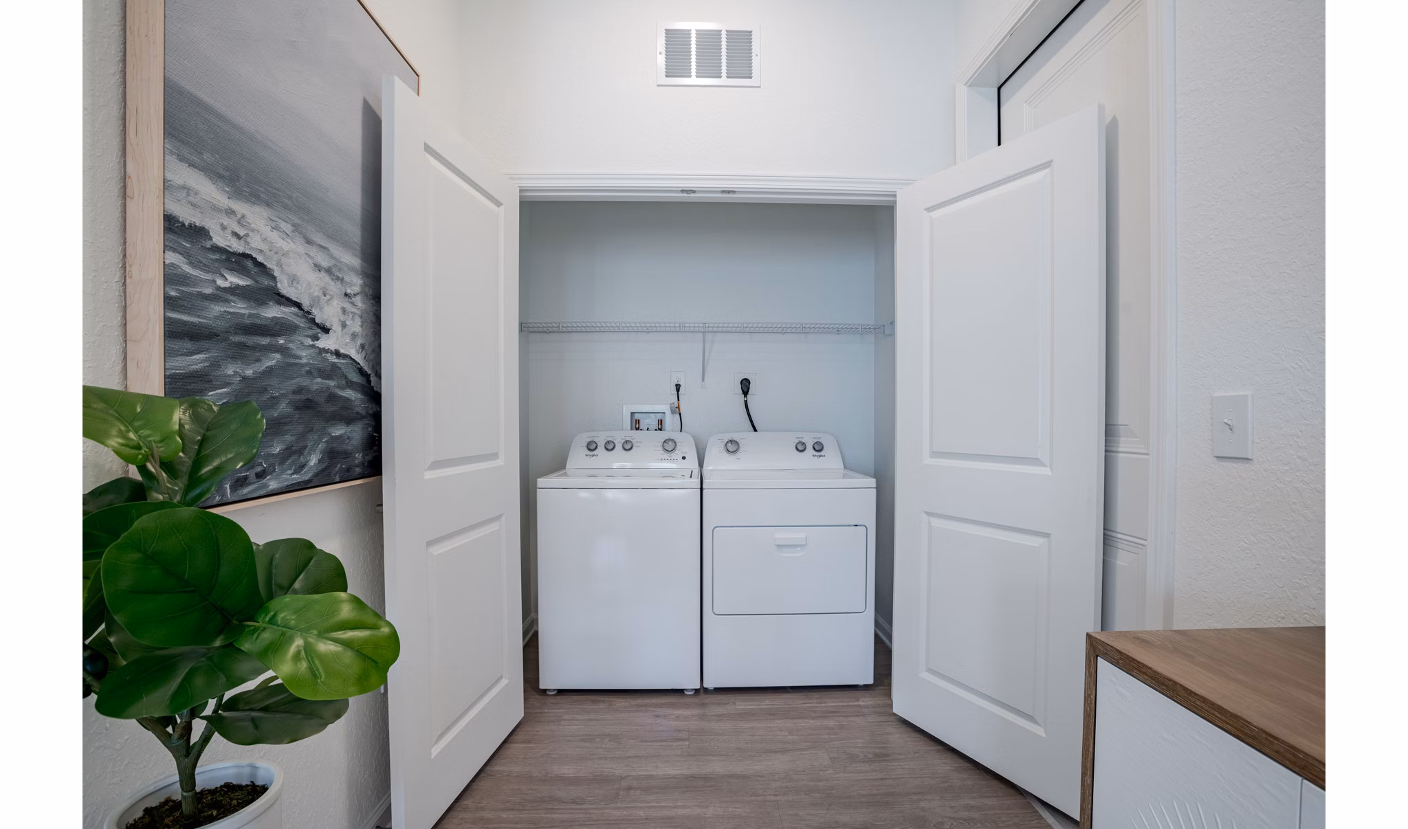 Laundry room with high-efficiency washers and dryers at Eden Heritage Lakes Apartments