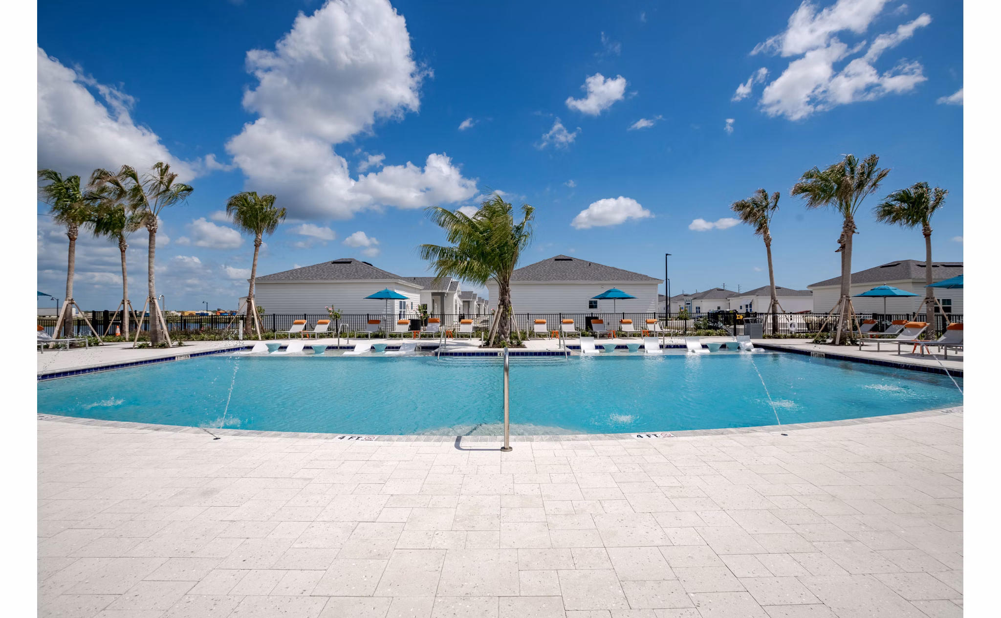 Resort-style pool with lounge chairs at Bay Court within Eden Heritage Lakes Apartments